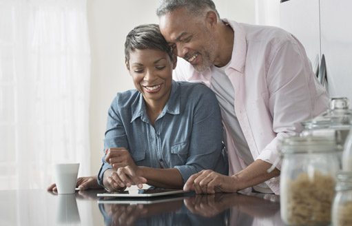 Premier AC & Heating LLC | Rock Hill, SC | couple looking at tablet in kitchen